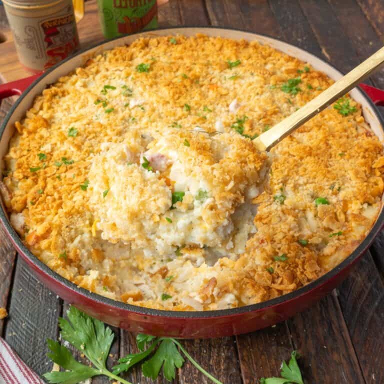 chicken hash brown casserole with a serving spoon scooping some out.