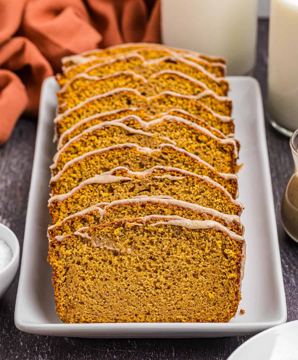 Several slices of pumpkin pound cake leaning against each other on a platter.