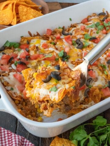 A spatula scooping up some dorito casserole.