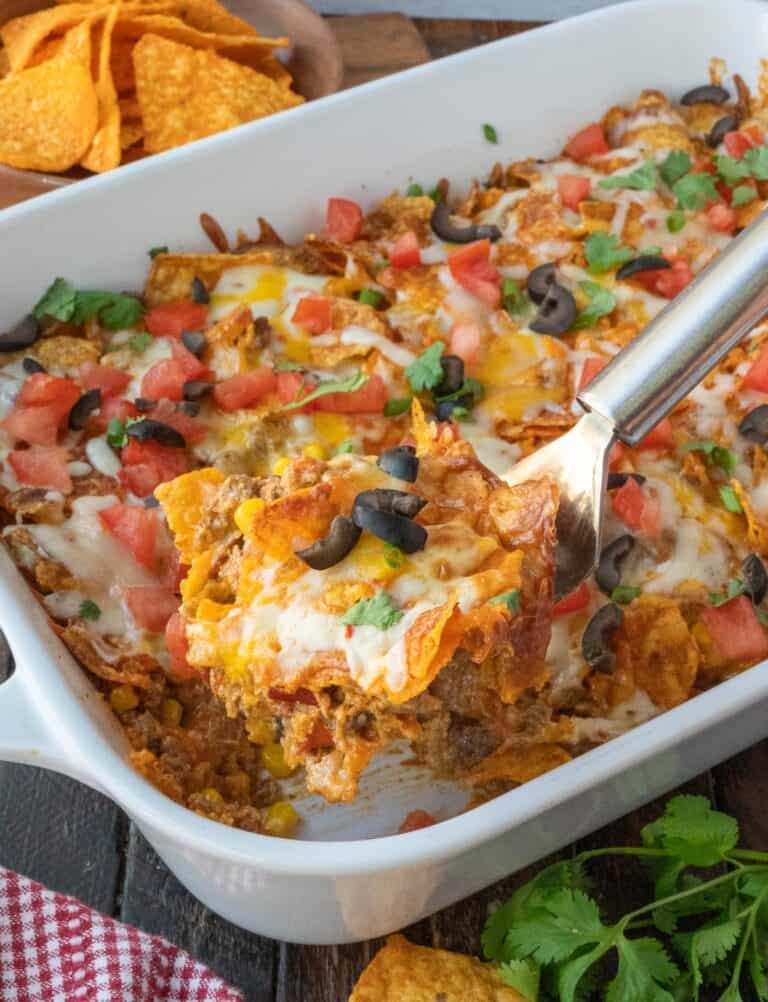 A spatula scooping up some dorito casserole.