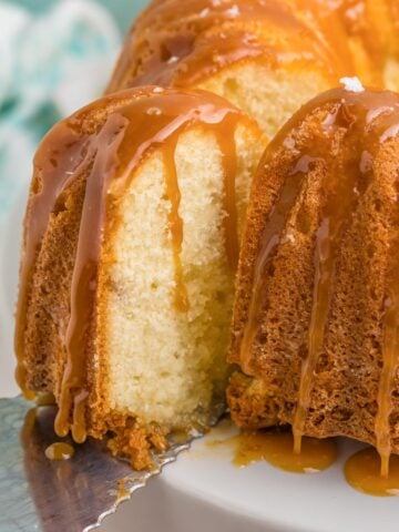 Separating a piece of bourbon butter cake from the rest of the cake.