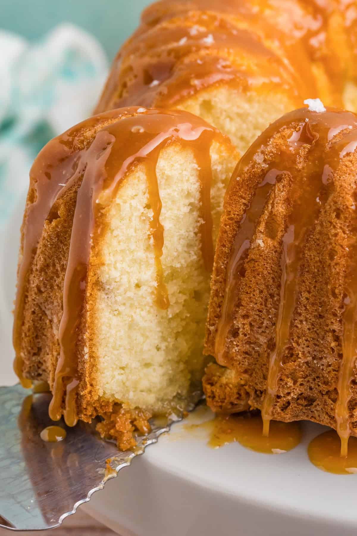 Separating a piece of bourbon butter cake from the rest of the cake.