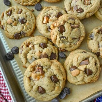 Snickers cookies on a plate with snickers bars.