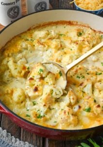 Cauliflower au gratin on a skillet with a spoon.