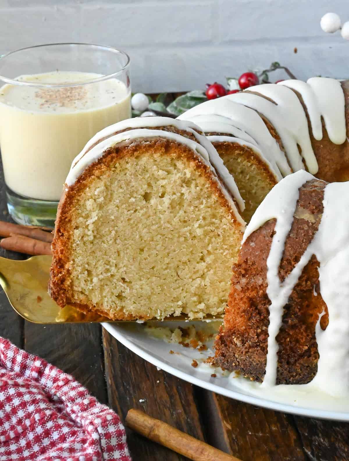 A spatula getting a slice of the eggnog pound cake.