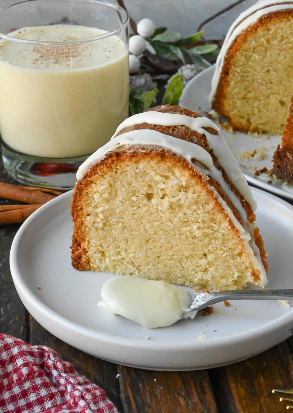 A slice of spiced eggnog pound cake on a plate.