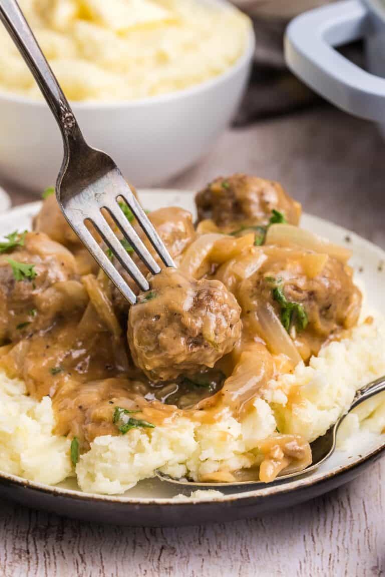 Meatballs with onion gravy served over mashed potatoes.