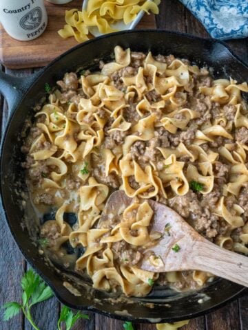 Beef and noodles in a cast iron skillet.