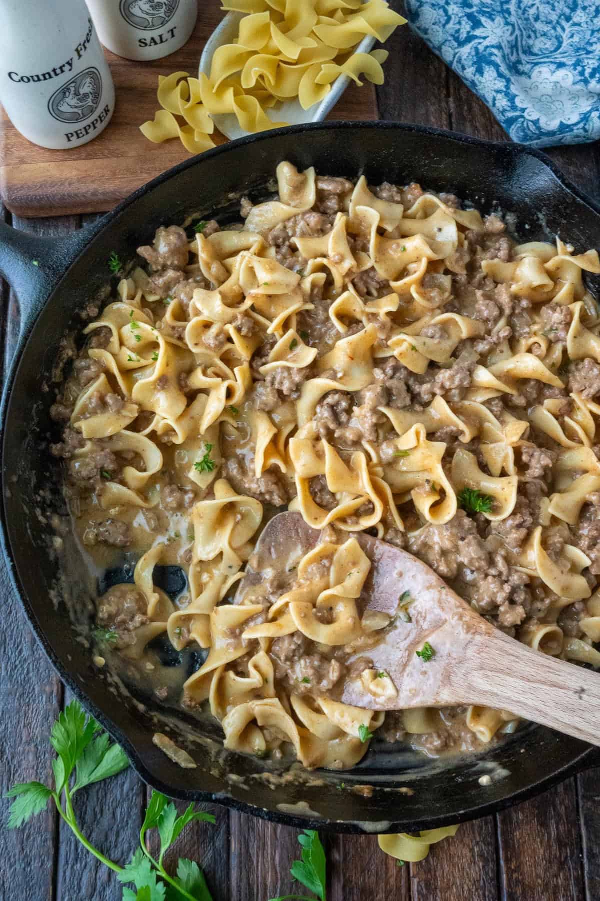 Beef and noodles in a cast iron skillet.