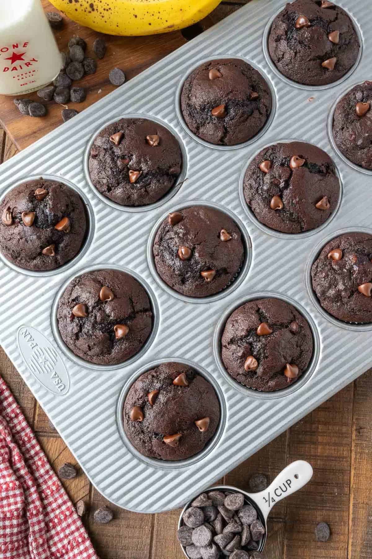 A muffin tin full of perfectly baked chocolate banana muffins.