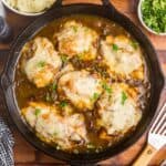 A large skillet full of french onion chicken bake.