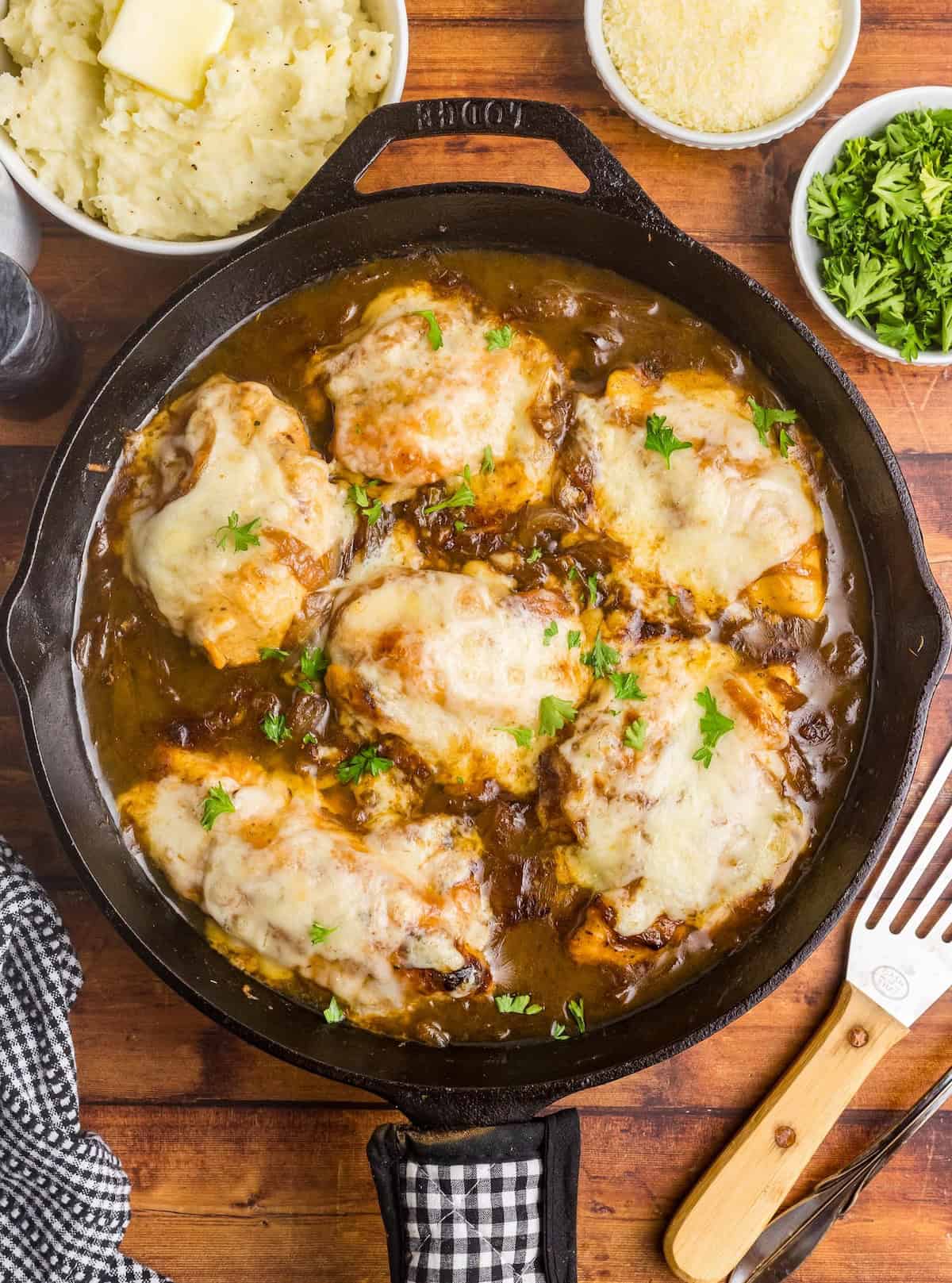 A large skillet full of french onion chicken bake.