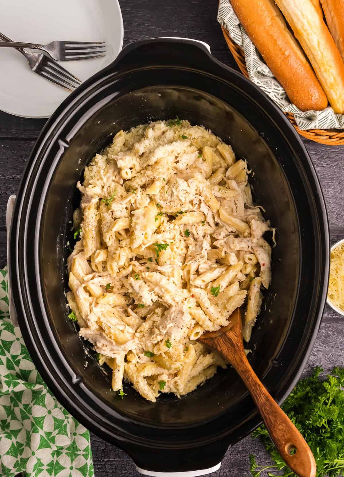 Top down view of a slow cooker full of olive garden chicken pasta.