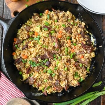 Overhead view of a skillet full of steak fried rice.