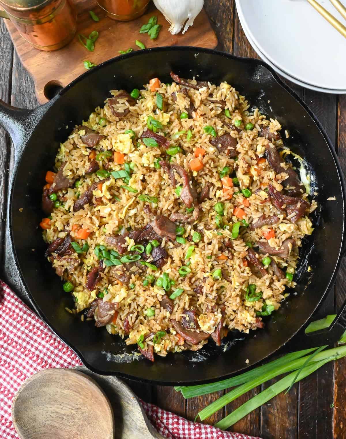 Overhead view of a skillet full of steak fried rice.