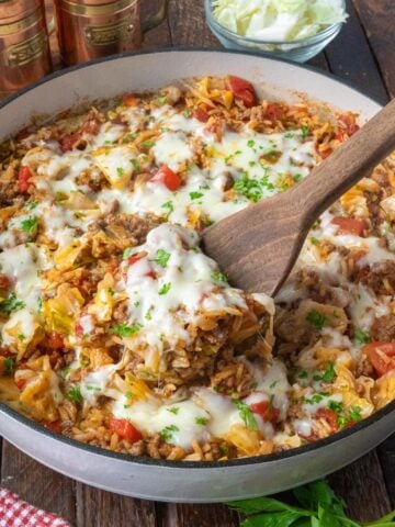 Using a spatula to take a scoop of unstuffed cabbage roll skillet.