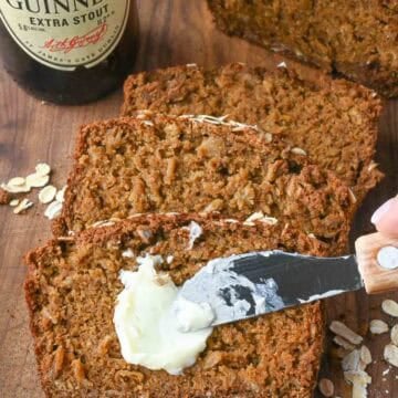 Spreading butter on a slice of guinness bread.