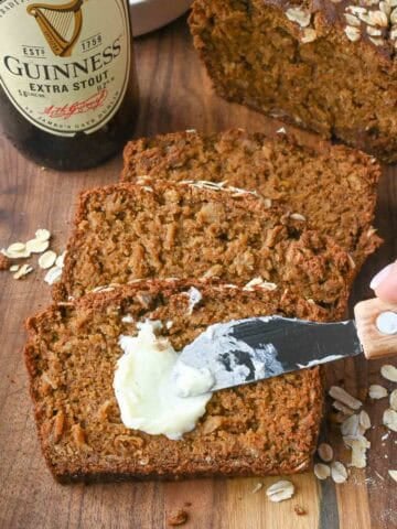 Spreading butter on a slice of guinness bread.