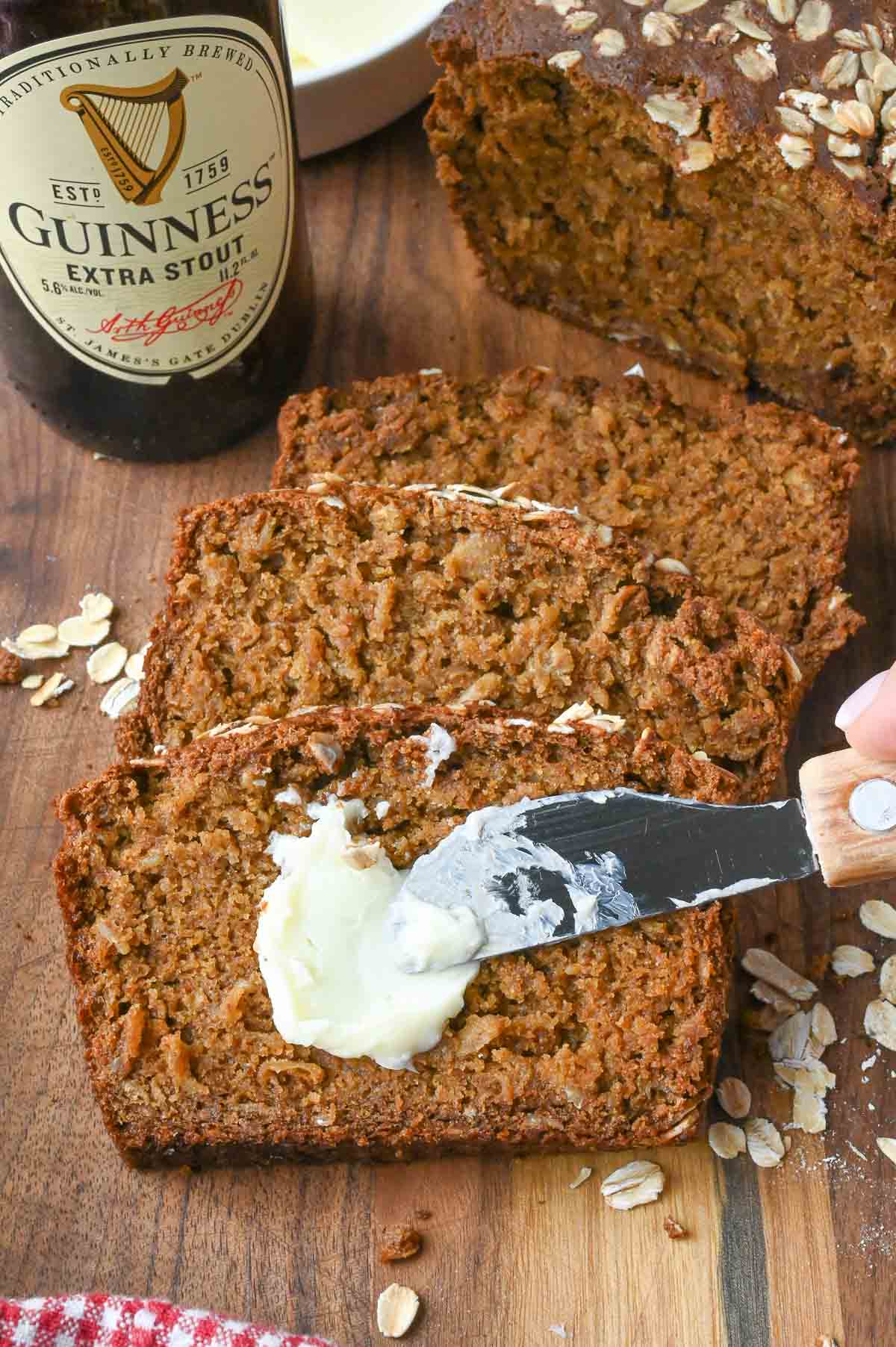 Spreading butter on a slice of guinness bread.