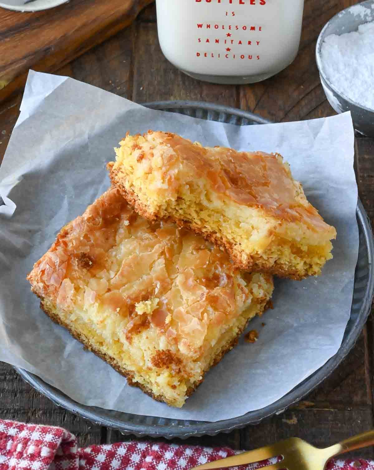 Two butter cake bar squares on a plate.