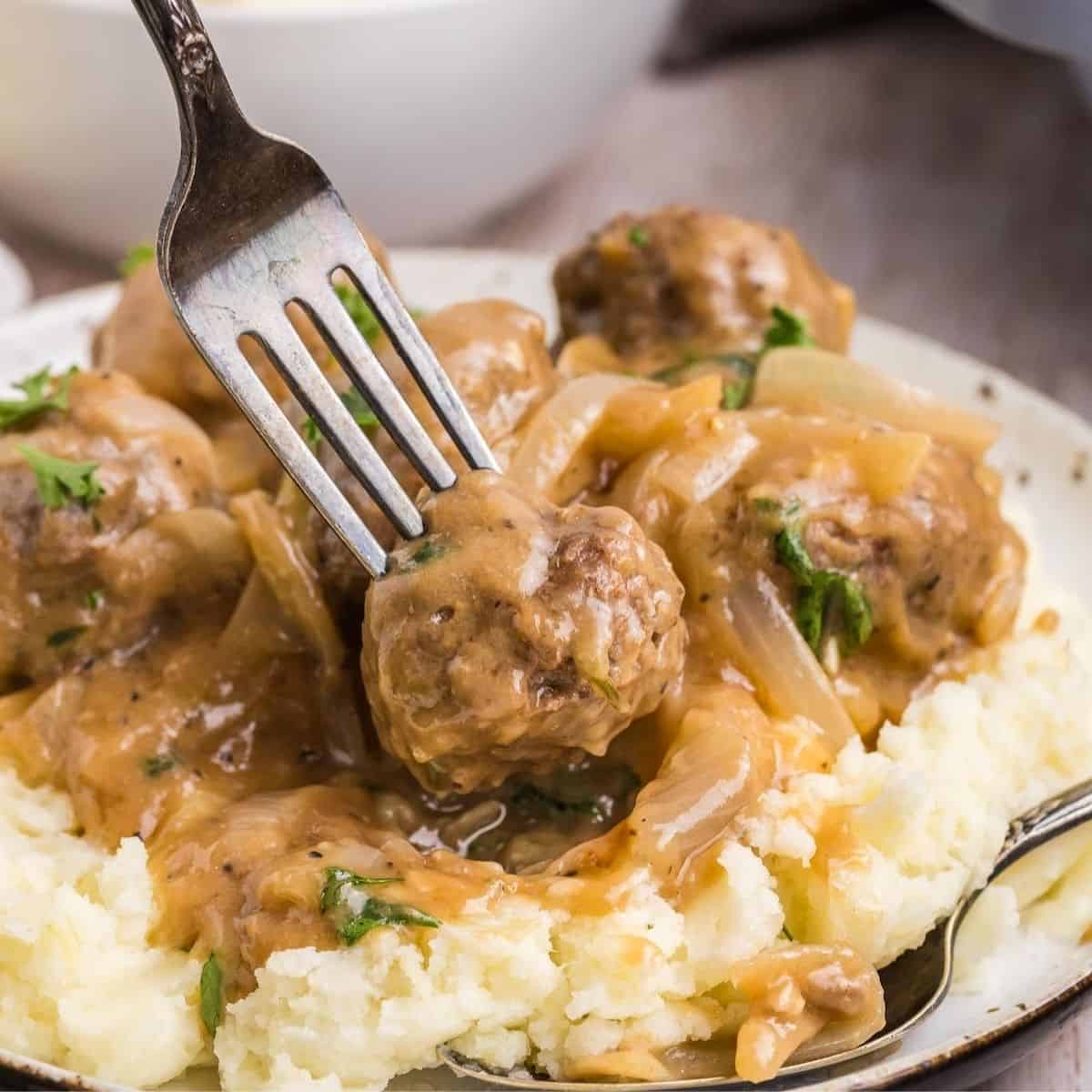 Main dish entree of meatballs on a bed of mashed potatoes.