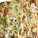 Tuscan chicken orzo in a casserole dish pinterest pin.