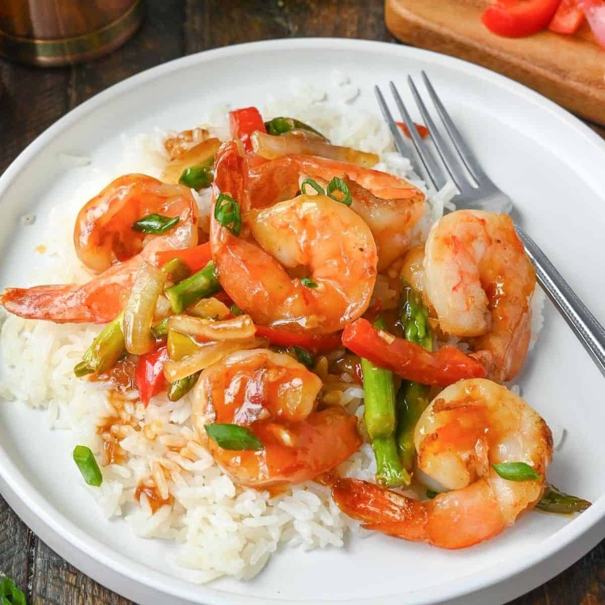 Seafood dinner with shrimp and rice on a white plate.