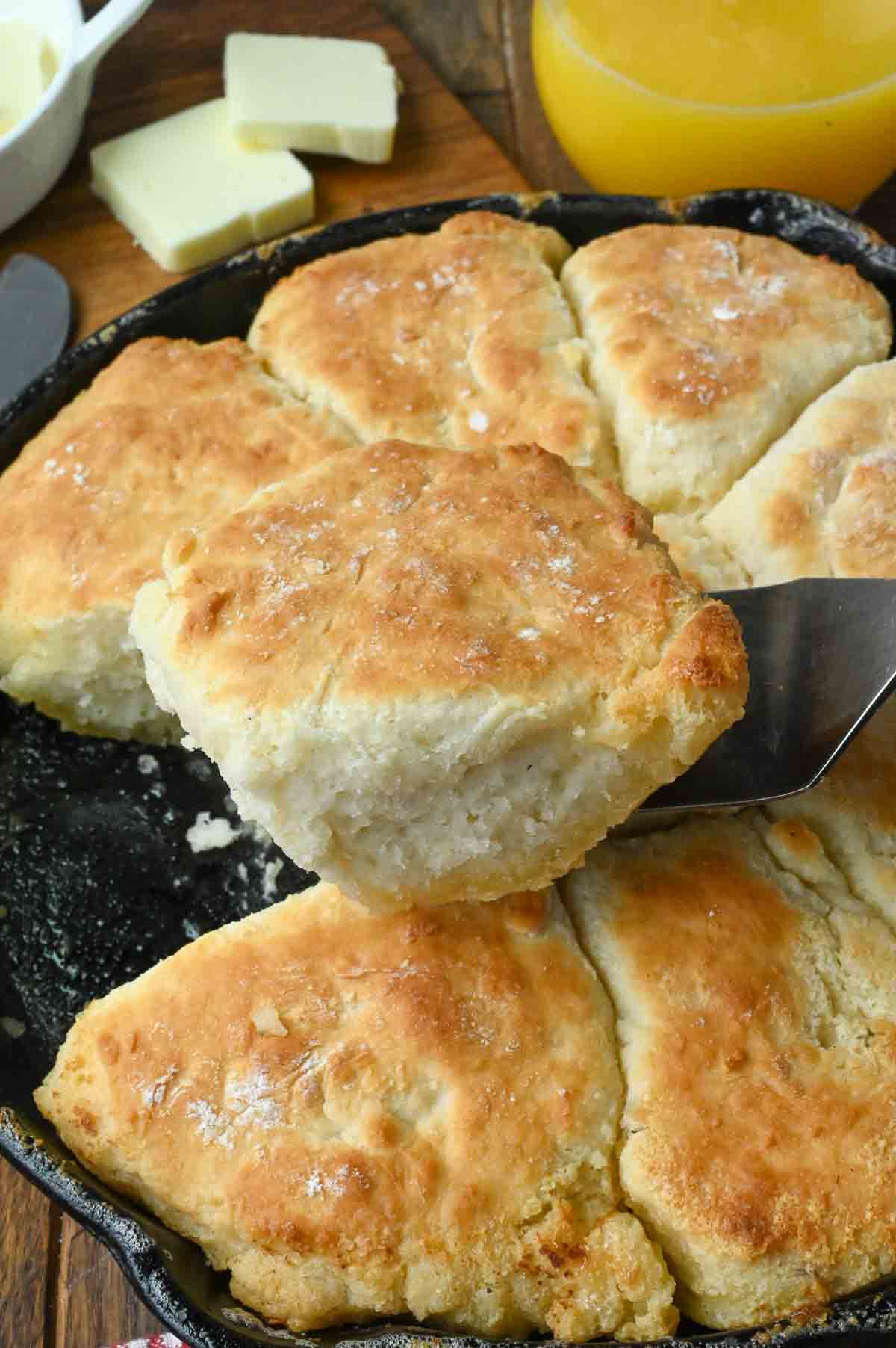 Lifting a 7 up biscuit from a skillet.