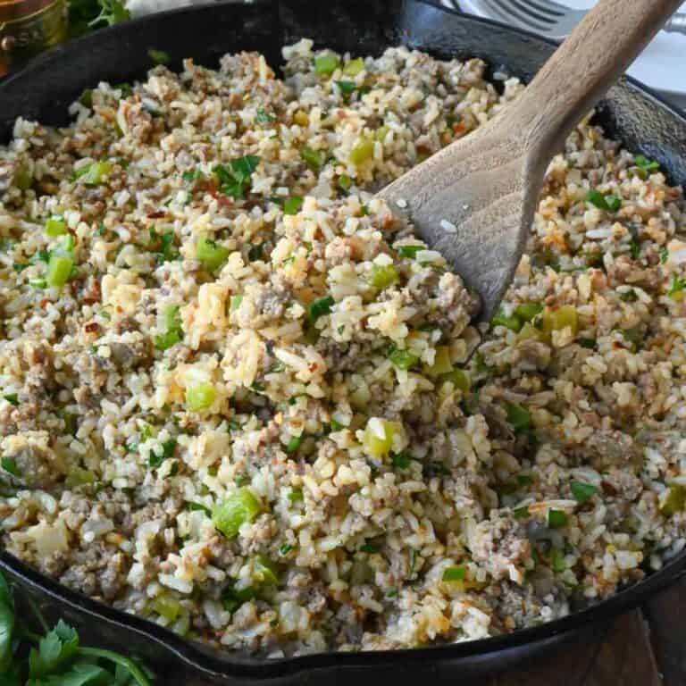 A spoon scooping up some dirty rice.