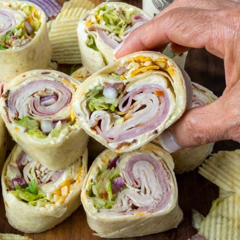 Turkey ham pinwheel being picked up.