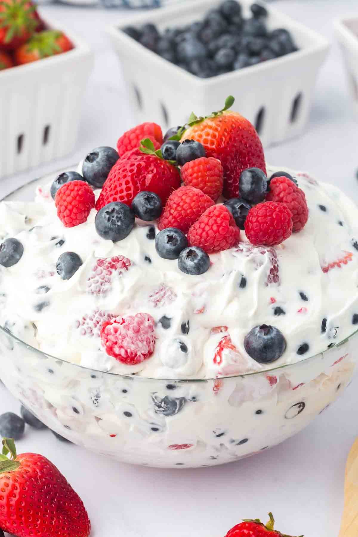 A bowl of cheesecake salad topped with fresh fruit.