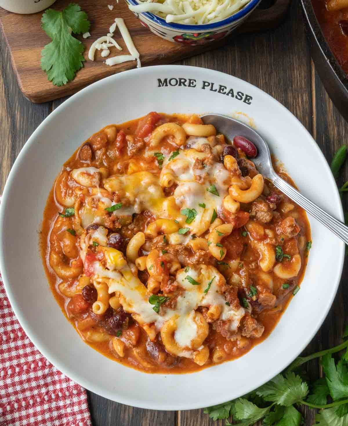Chili mac in a white plate with a fork.