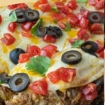 A spatula scooping up a piece of taco lasagna pinterest pin.