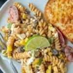 Mexican street corn pasta salad on a plate pinterest pin.