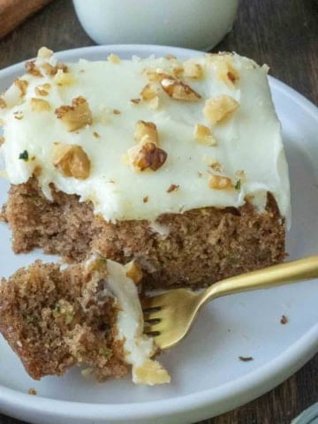 Close up of a slice of zucchini cake on a plate.