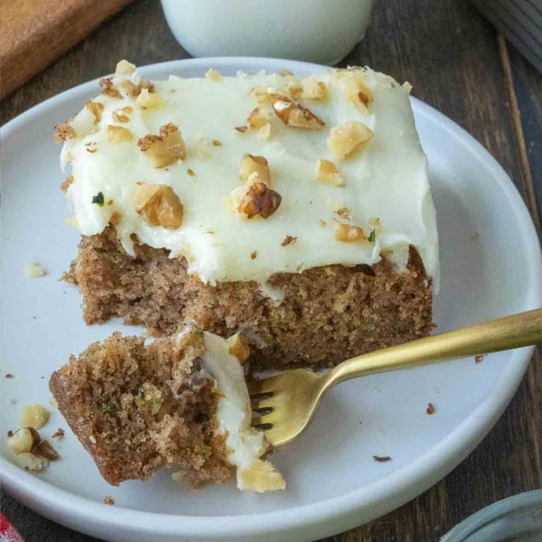 Close up of a slice of zucchini cake on a plate.