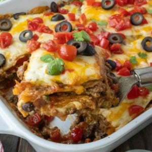 A spatula picking up a serving of taco lasagna