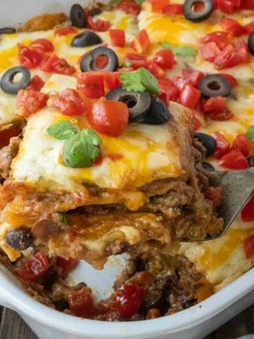 A spatula picking up a serving of taco lasagna