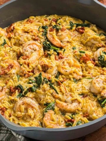 A pot full of tuscan shrimp orzo skillet.