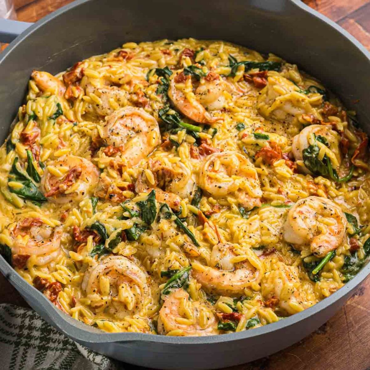 A pot full of tuscan shrimp orzo skillet.