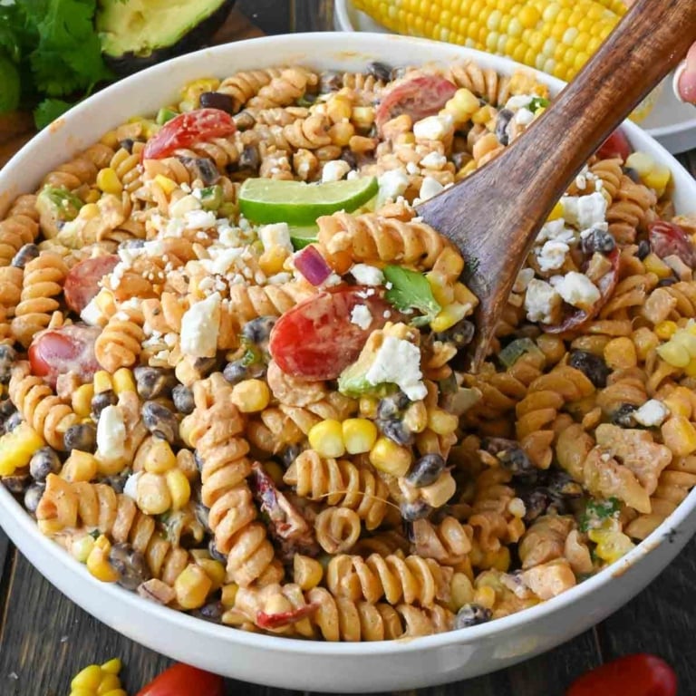 Street corn pasta salad with a serving spoon.
