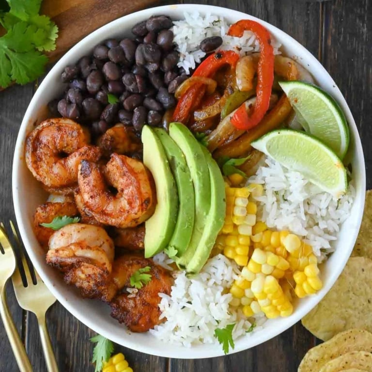 Overhead view of a shrimp bowl with fajita veggies.