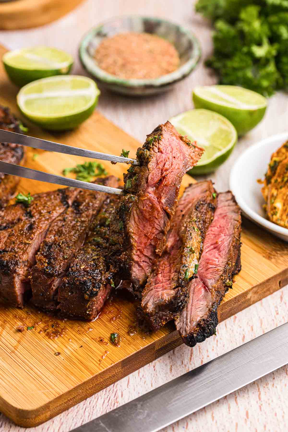 Sliced grilled top sirloin steak with cajun butter.