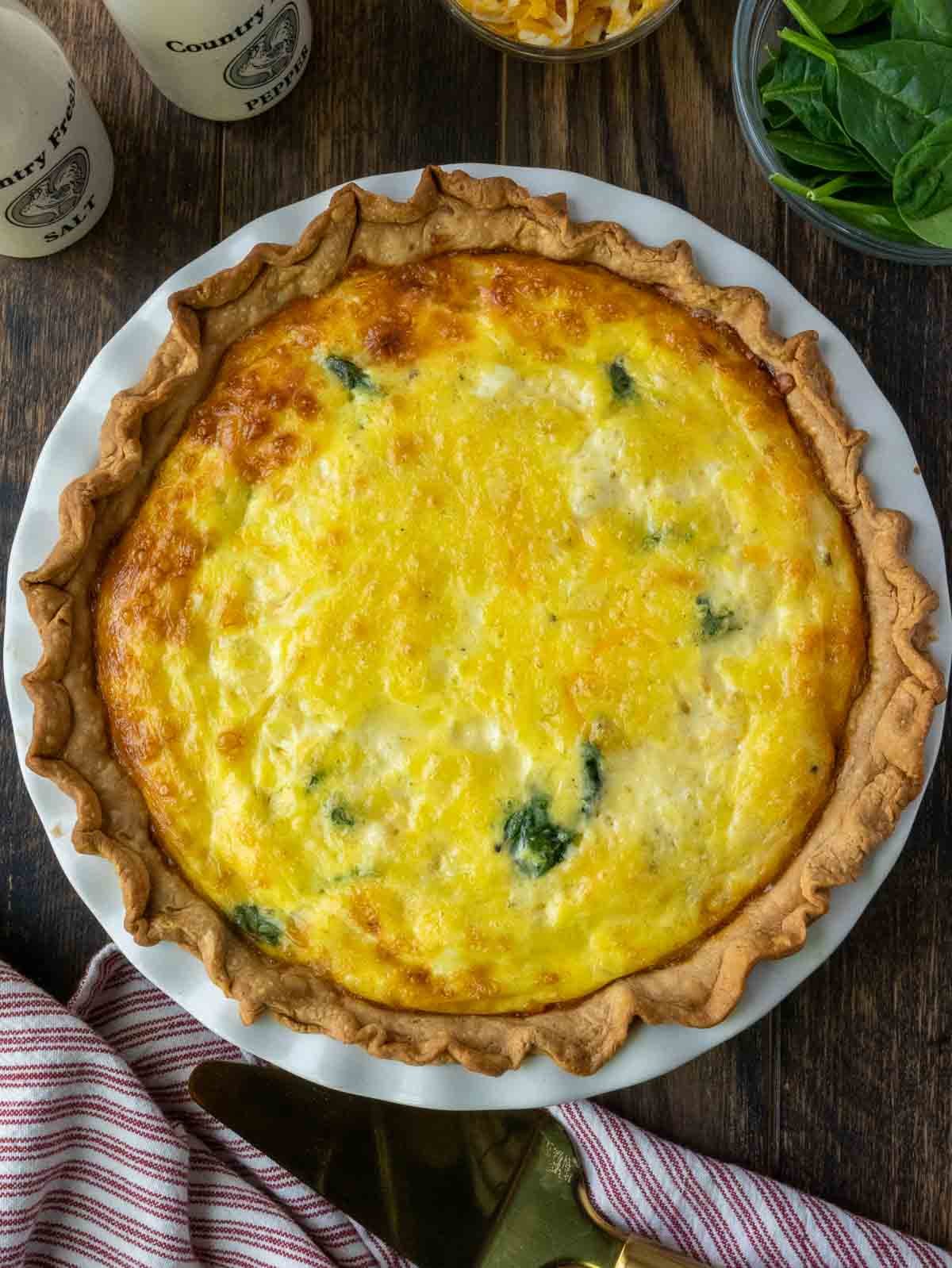 Sausage spinach quiche in a pie dish.