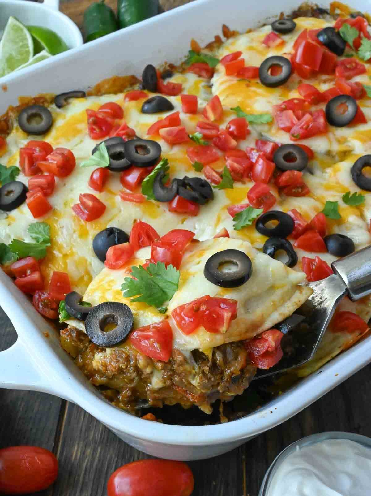 Taco lasagna in a white baking dish.