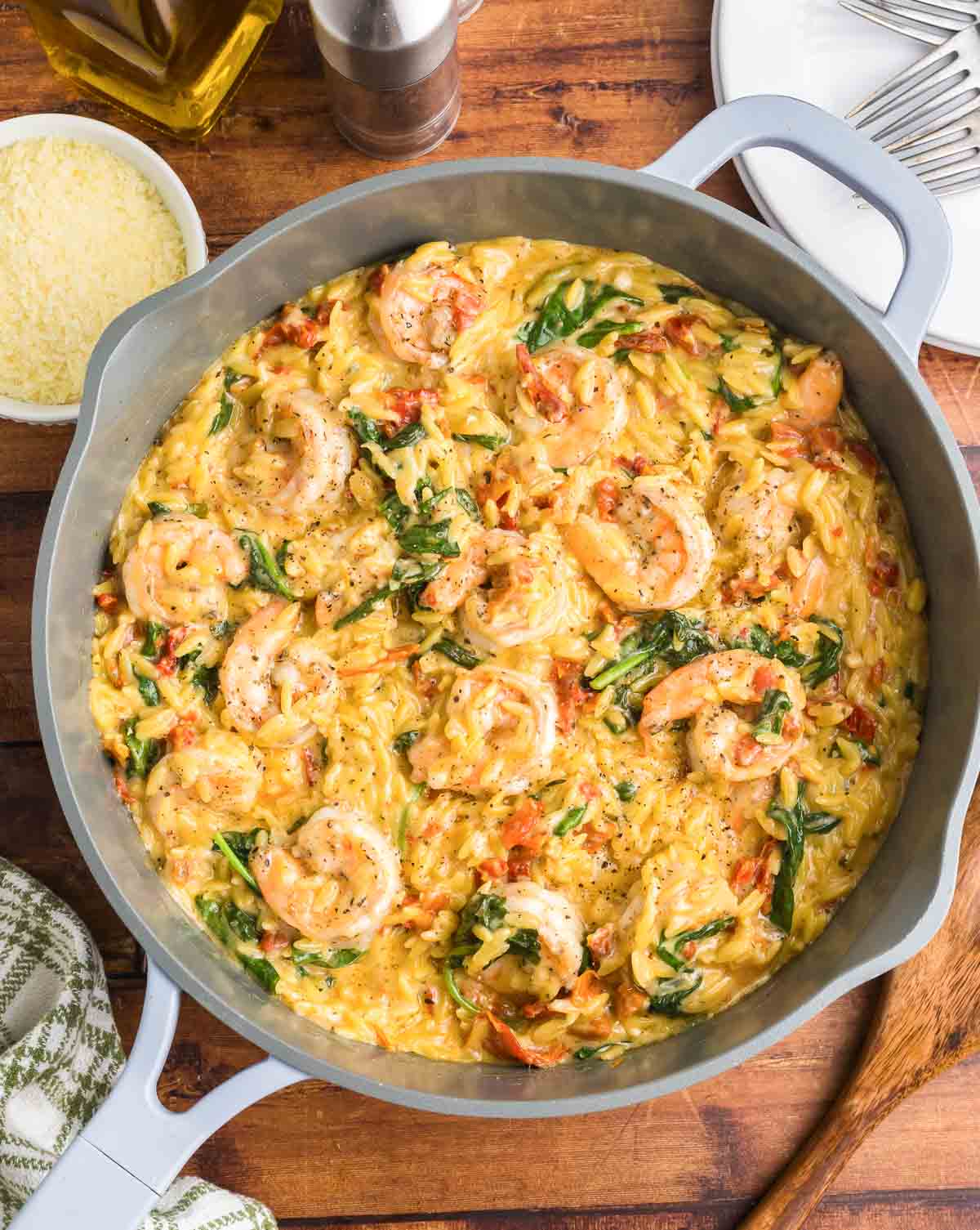 A skillet full of orzo pasta with shrimp.