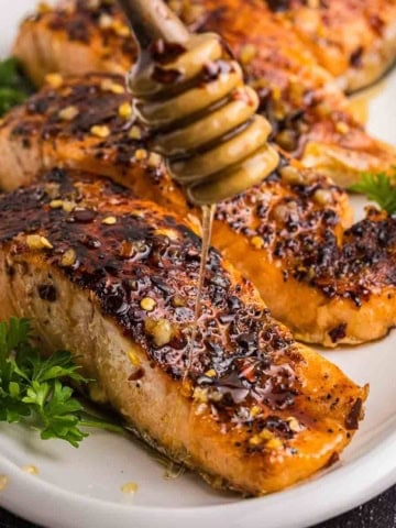 Drizzling honey over hot honey salmon.