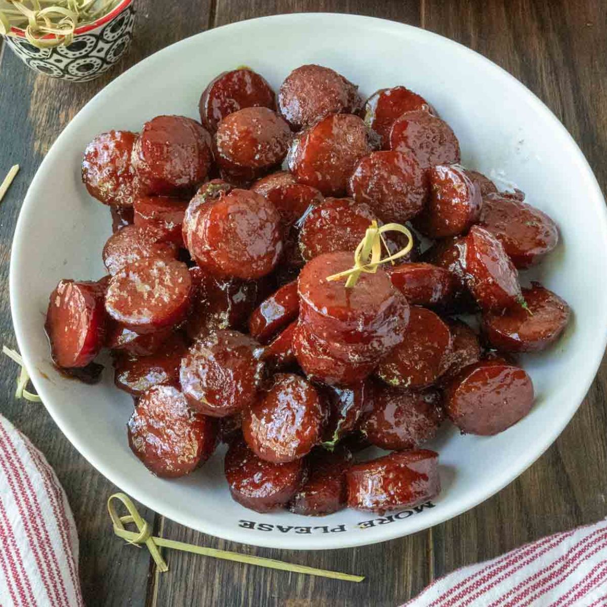 Kielbasa bites on a platter with a toothpick.