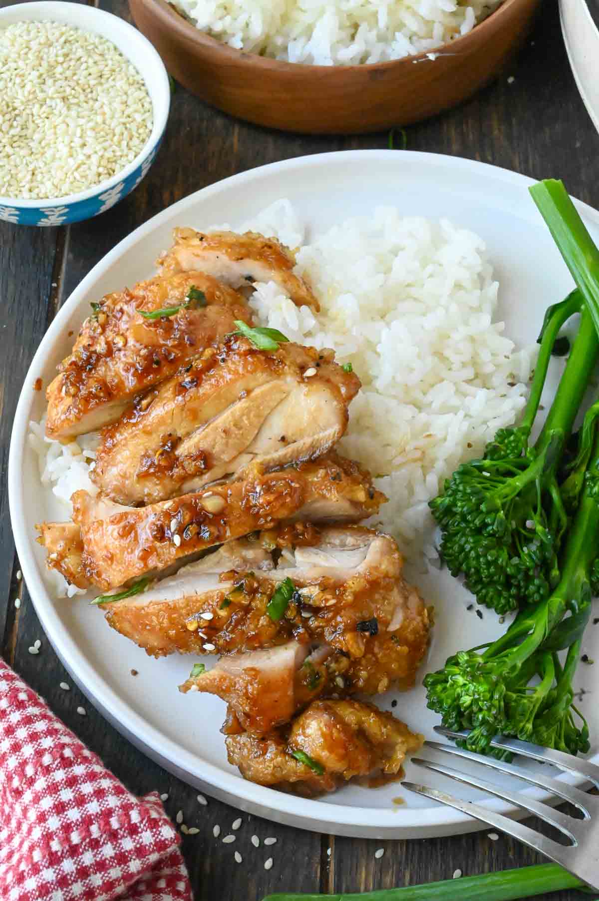 A plate of soy garlic chicken with rice and broccoli.
