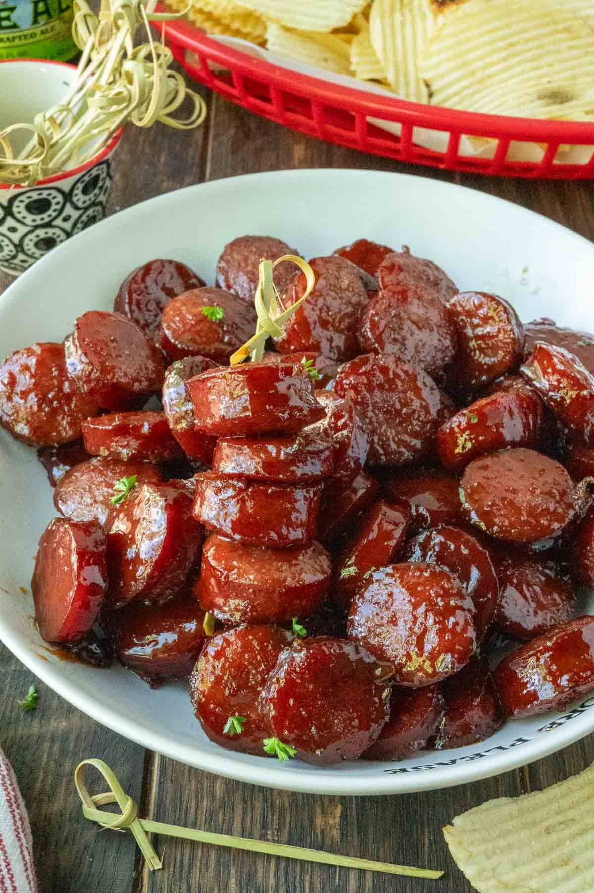Kielbasa bites on a platter with toothpicks.